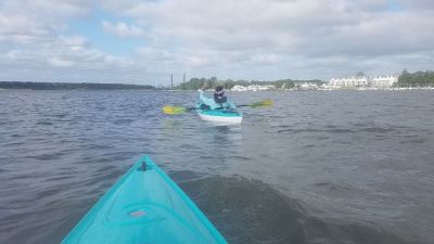 Who is she waving to?
